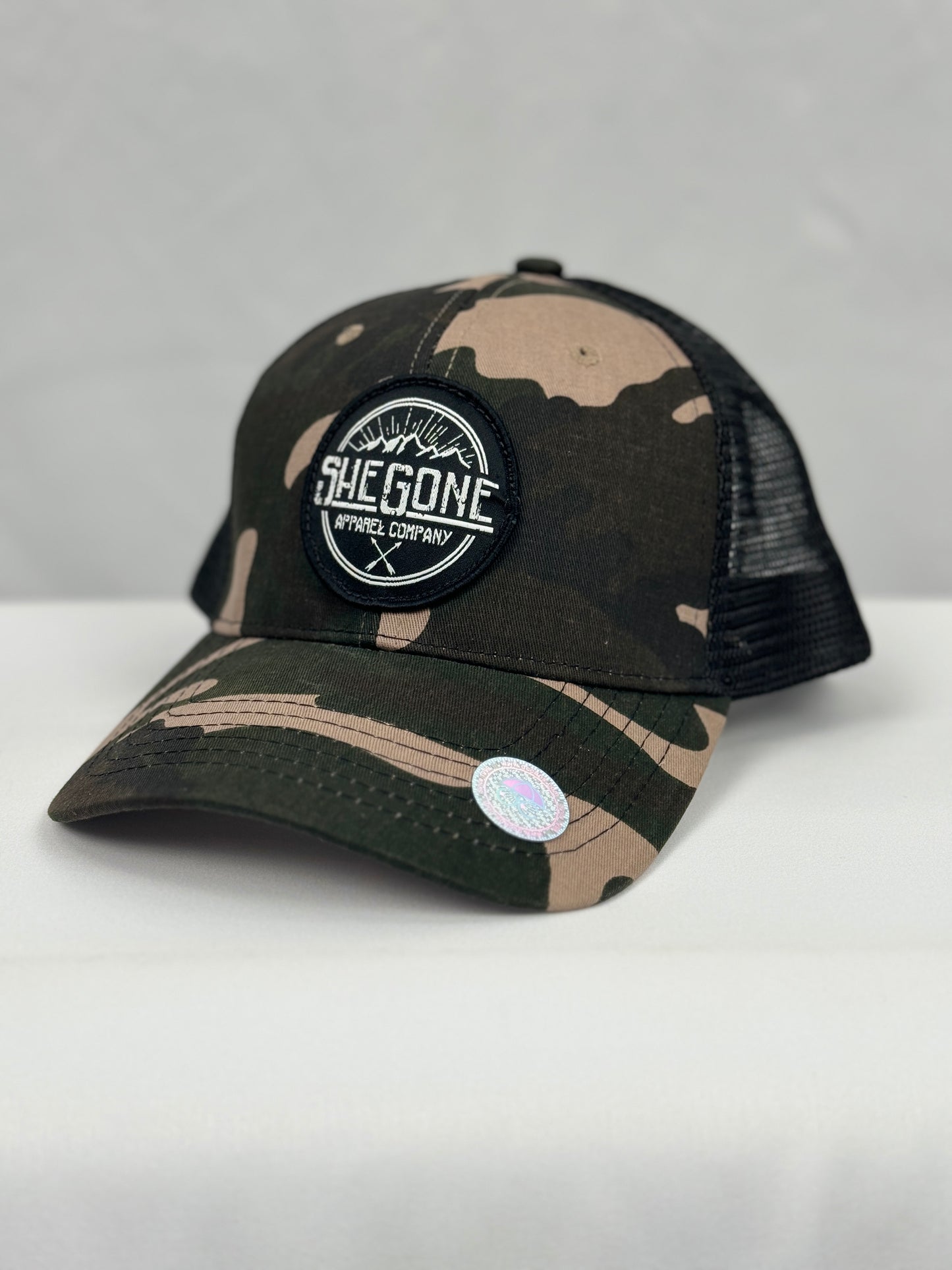 Woven SheGone Circle Patch on 6638 Camo Trucker Cap - Camo/ Black